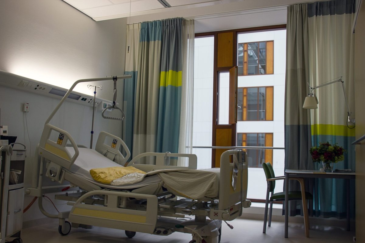 Das Bild zeigt ein leeres Pflegebett in einem Krankenhaus.